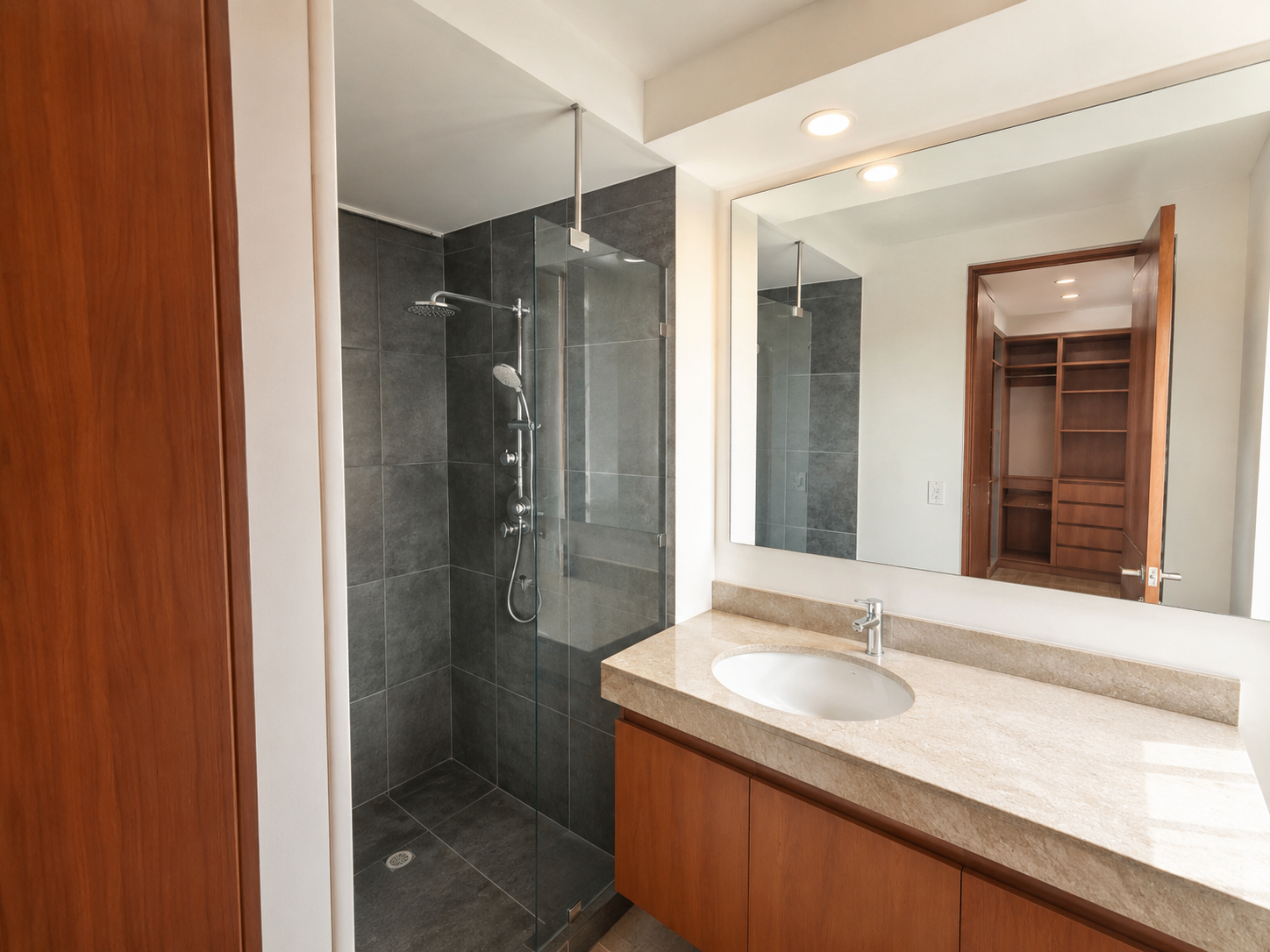 Baño secundario con ducha en piedra y walk-in closet